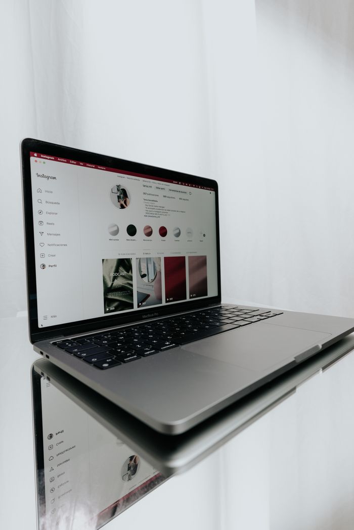 creative-01 A sleek laptop showing an Instagram profile, highlighting modern technology and internet connectivity.